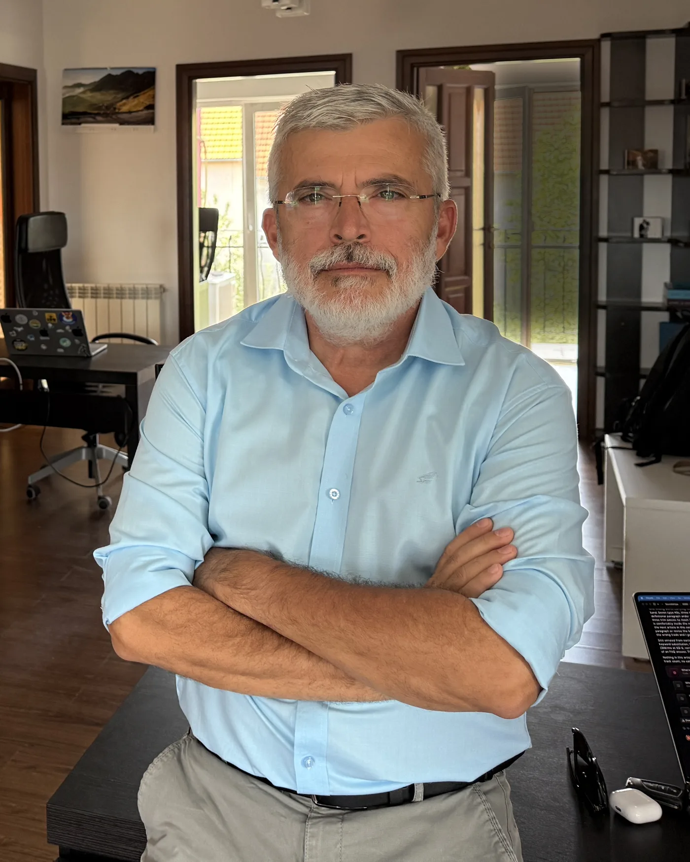 Paul Pasztor, arms crossed, in the MindGrid office